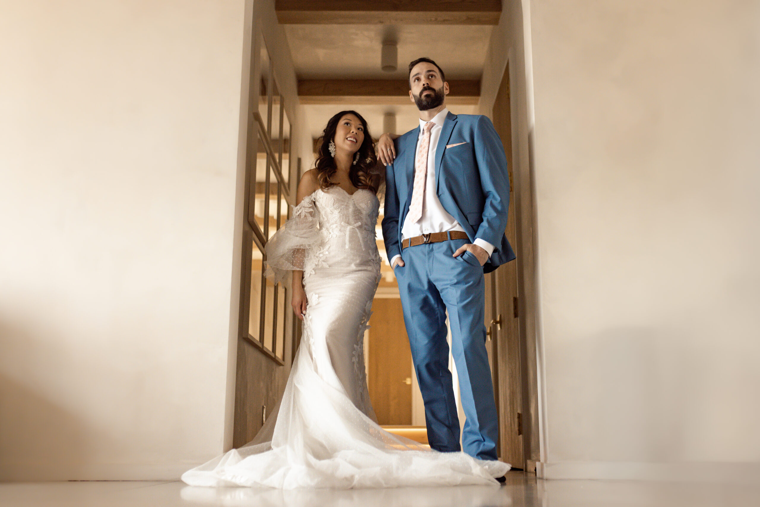 A wedding couple standing together leaning against the wall during their elopement day